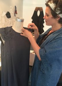 fashion designer lisa rietz draping a dress form with black fabric