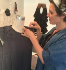 fashion designer lisa rietz draping a dress form with black fabric