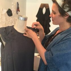 fashion designer lisa rietz draping a dress form with black fabric